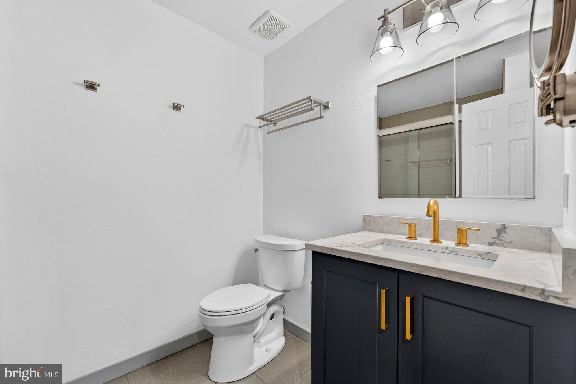207 Park Street Vienna, VA 22180 - Photo 33 of 45 a bathroom with a sink vanity mirror and toilet