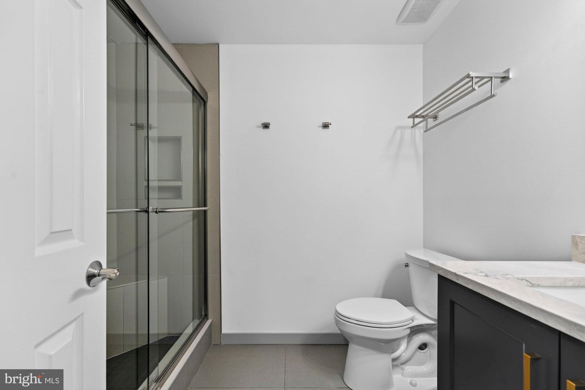 207 Park Street Vienna, VA 22180 - Photo 34 of 45 a white toilet sitting next to a bathroom sink