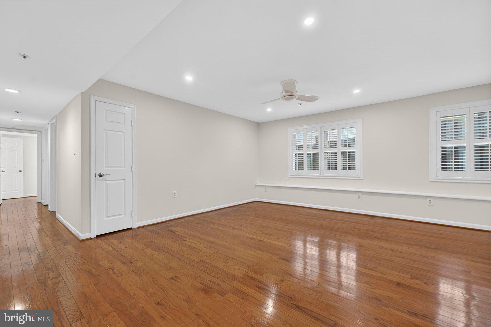207 Park Street Vienna, VA 22180 - Photo 8 of 45 a view of an empty room with wooden floor and windows