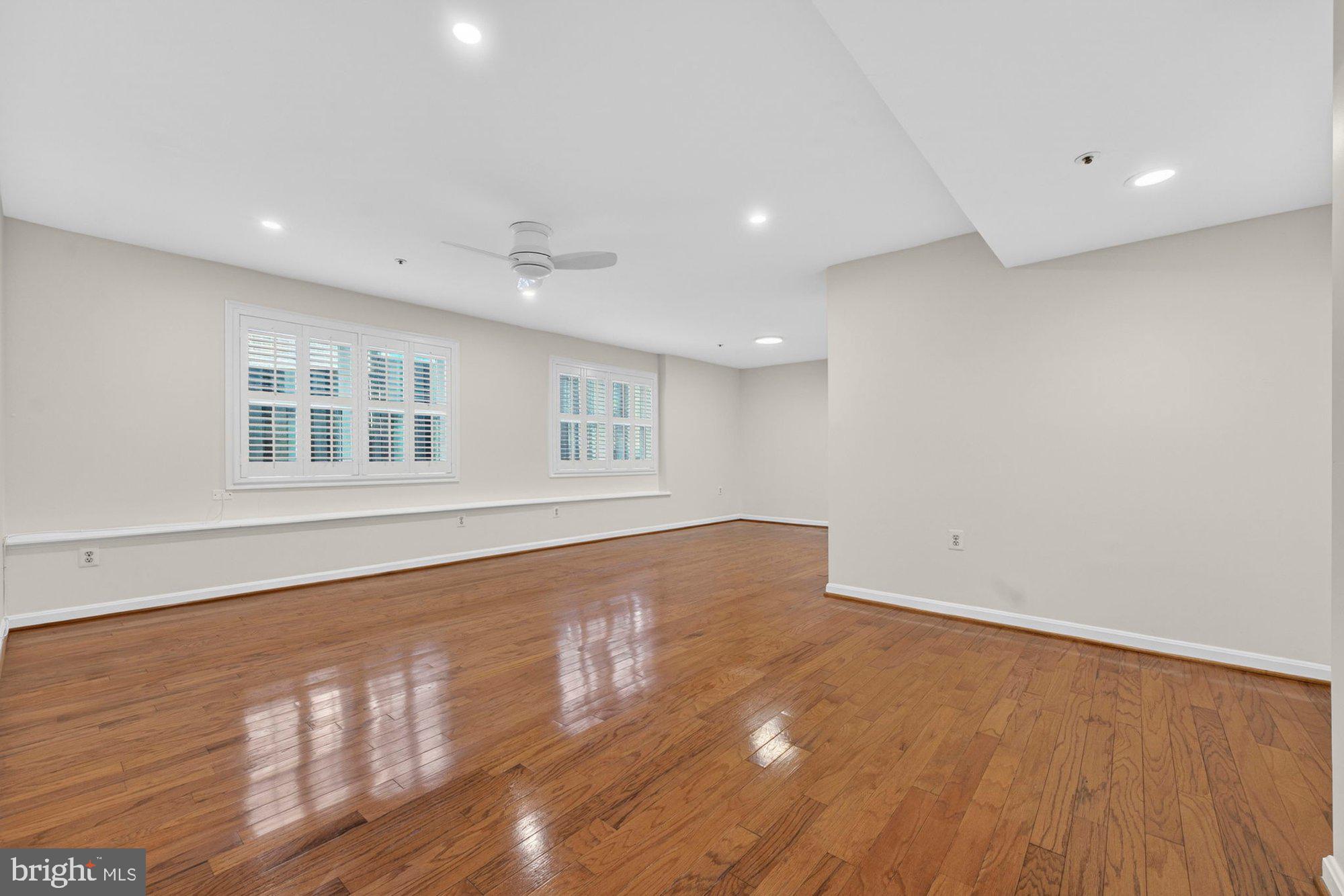 207 Park Street Vienna, VA 22180 - Photo 9 of 45 a view of an empty room with wooden floor and a window