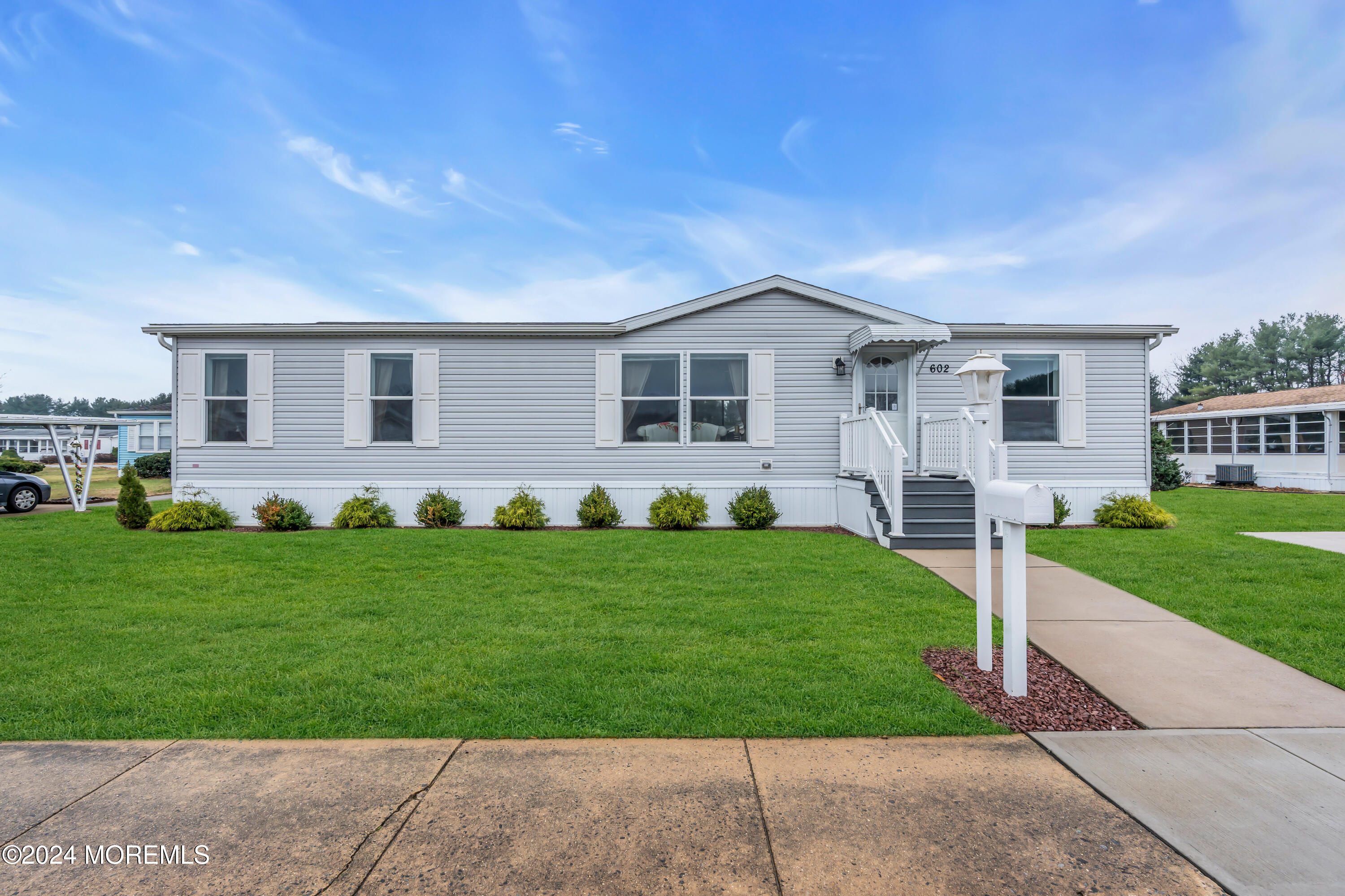 a front view of house with yard and green space