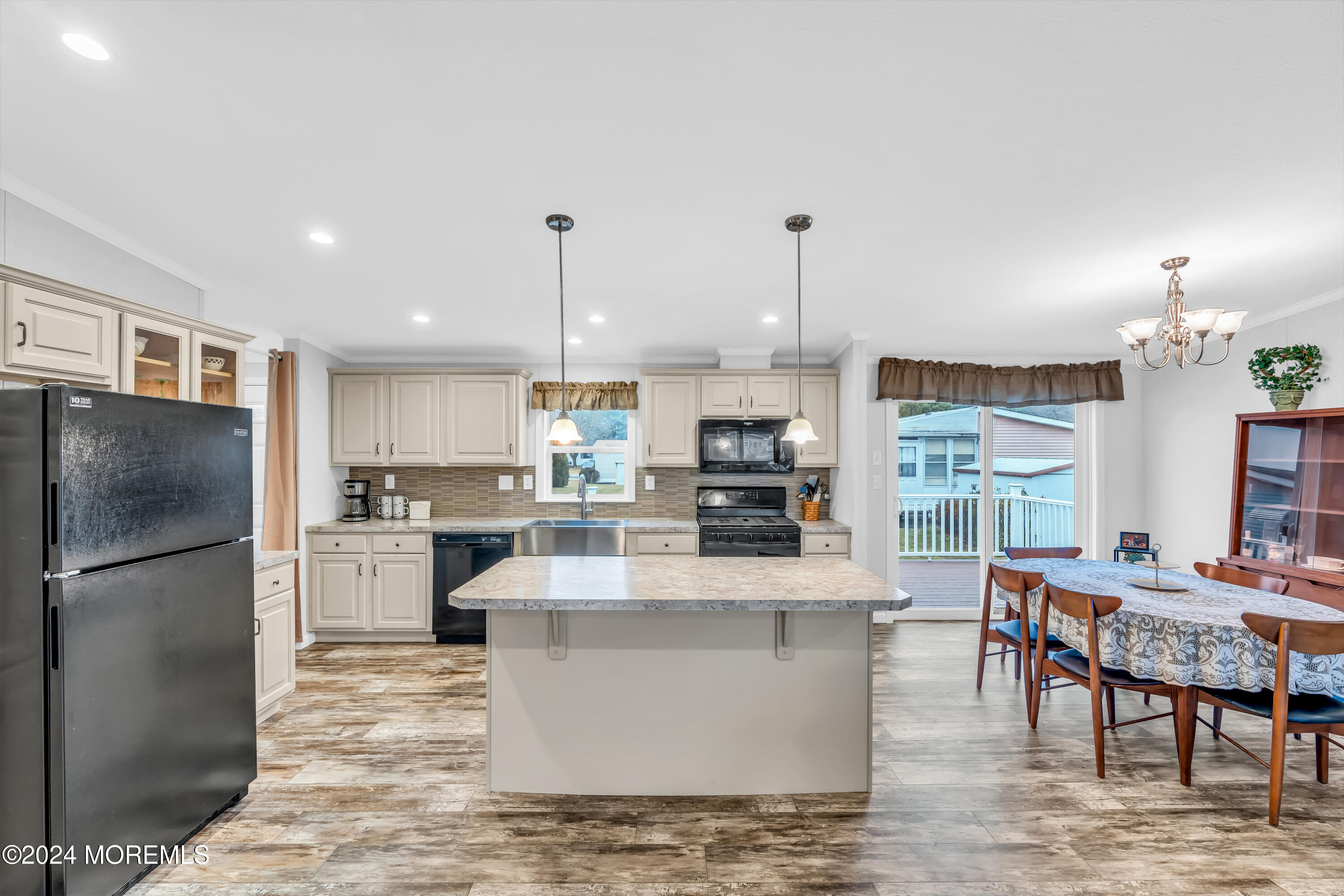 602 Jerome Place Freehold, NJ 07728 - Photo 23 of 55 a large kitchen with stainless steel appliances kitchen island granite countertop a refrigerator a stove a sink a dining table and chairs