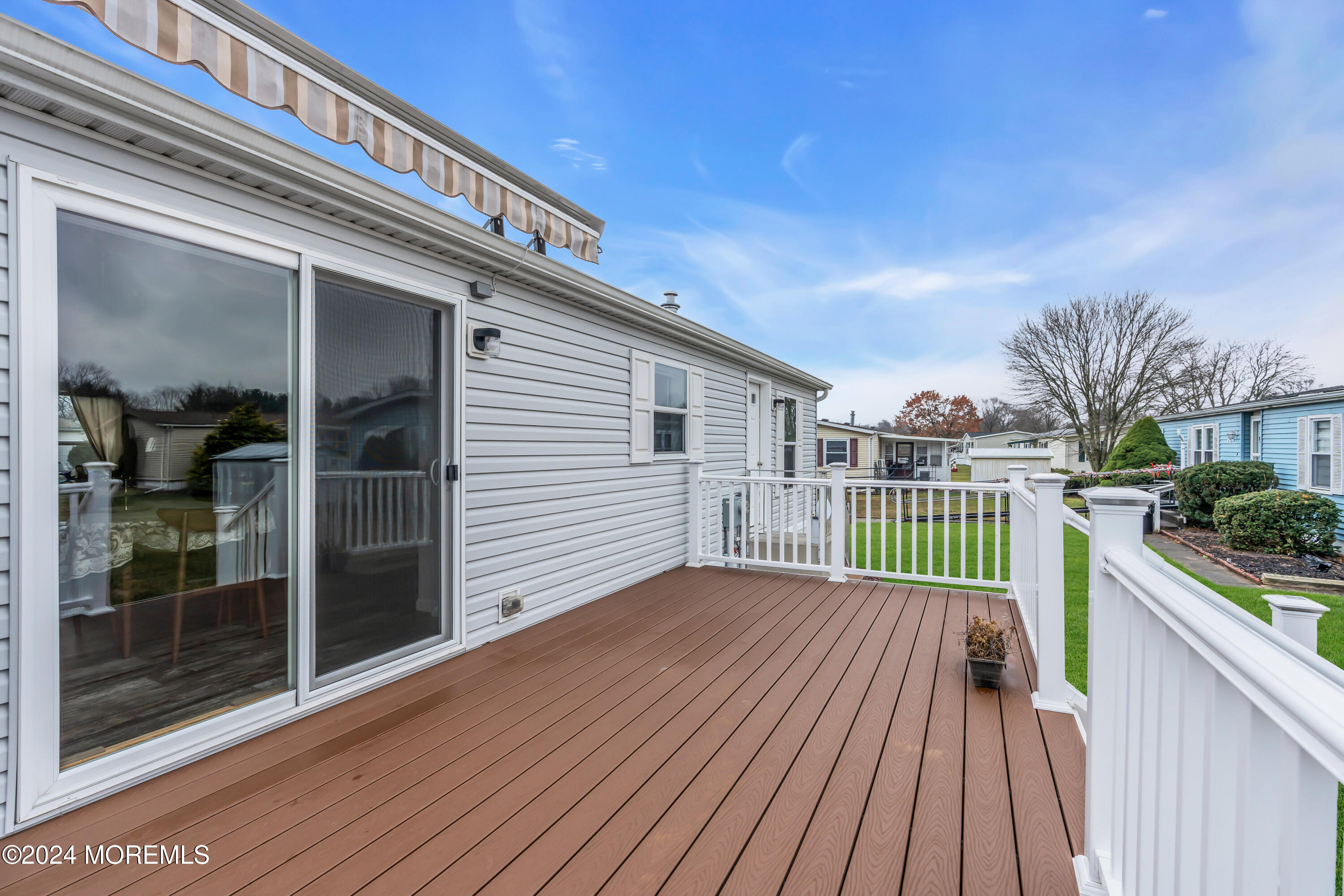 602 Jerome Place Freehold, NJ 07728 - Photo 53 of 55 a view of a balcony with a large window and wooden floor