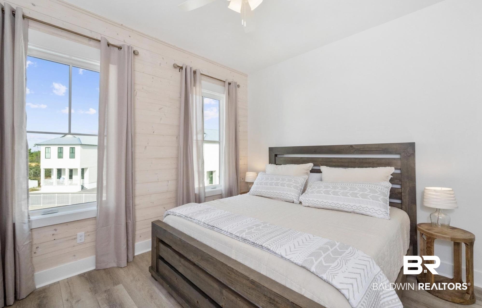 20 West Gate Orange Beach, AL 36561 - Photo 8 of 15 Bedroom with wood finished floors, a ceiling fan, and wood walls