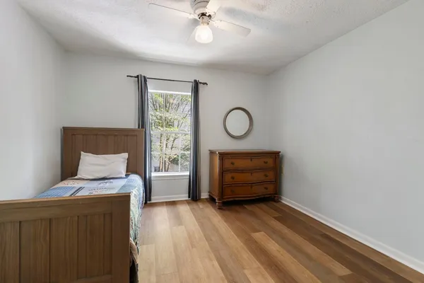 a spacious bedroom with a bed and a window
