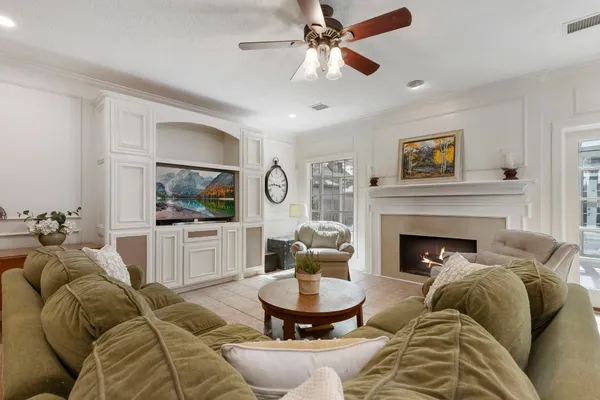 a living room with furniture and a ceiling fan