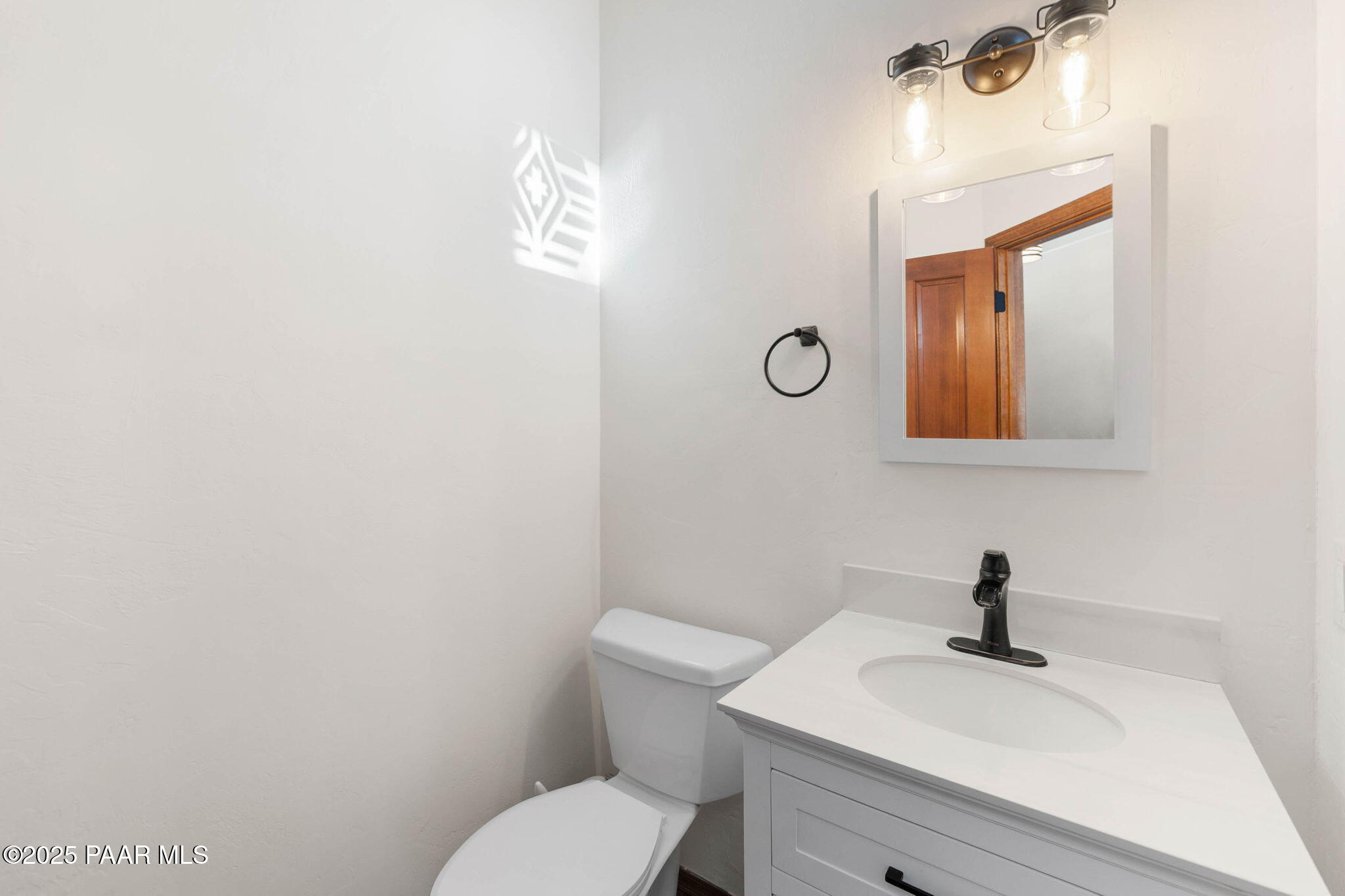 1219 Timber Point North Prescott, AZ 86303 - Photo 17 of 38 a bathroom with a toilet a sink and mirror
