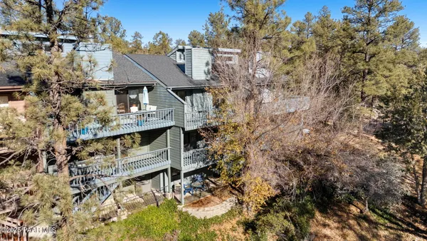 an aerial view of residential houses with outdoor space