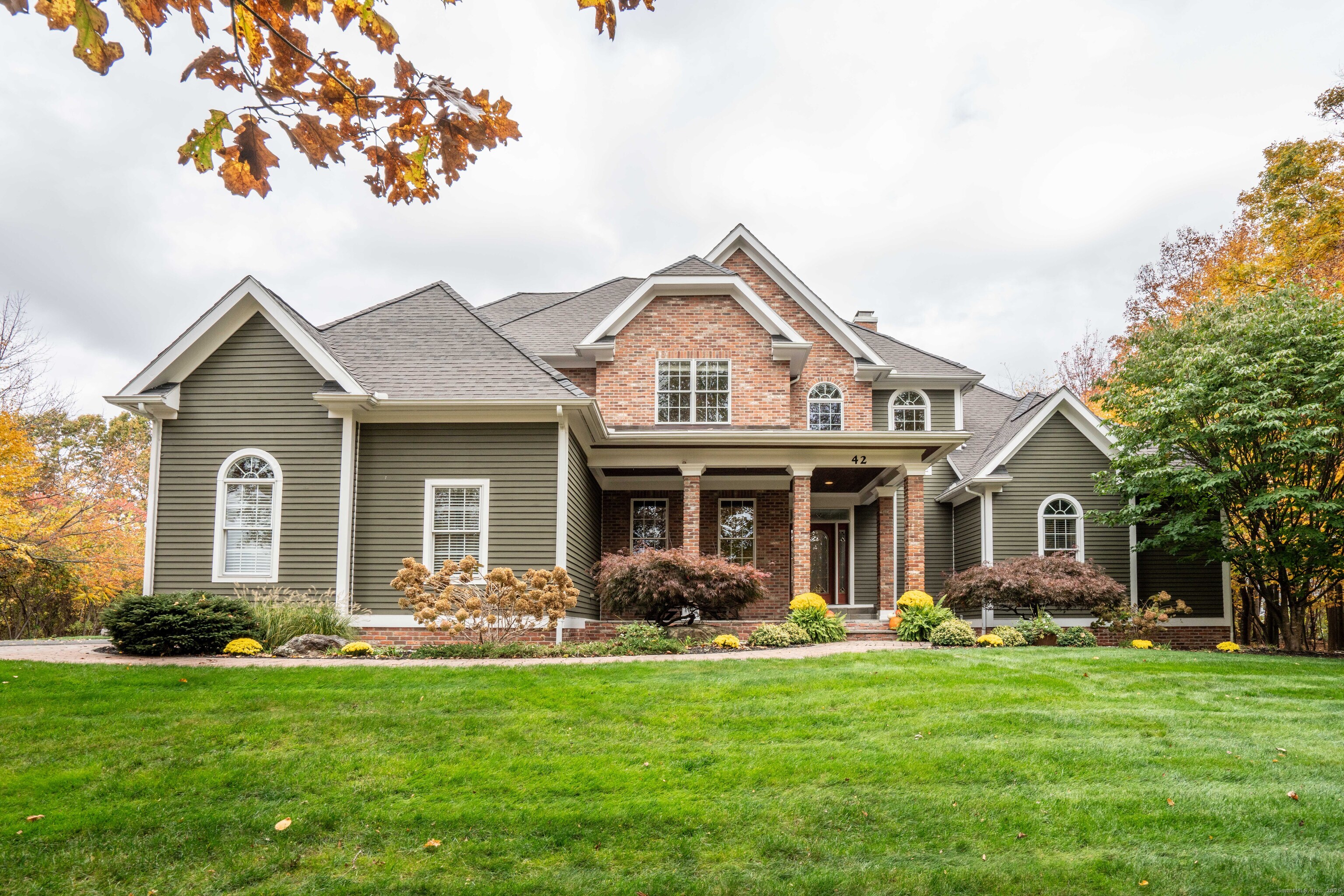 a front view of a house with a garden and patio