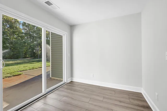 a view of a room with wooden floor and a lake view