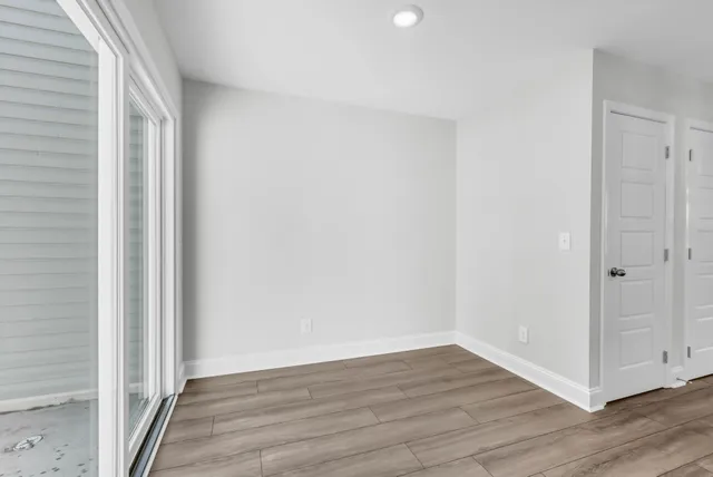 a view of a room with wooden floor