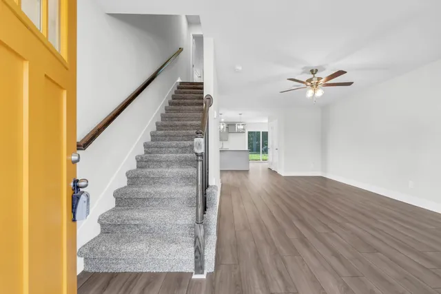 a view of entryway and hall with wooden floor