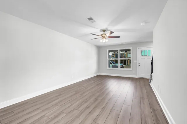 wooden floor in an empty room with a window