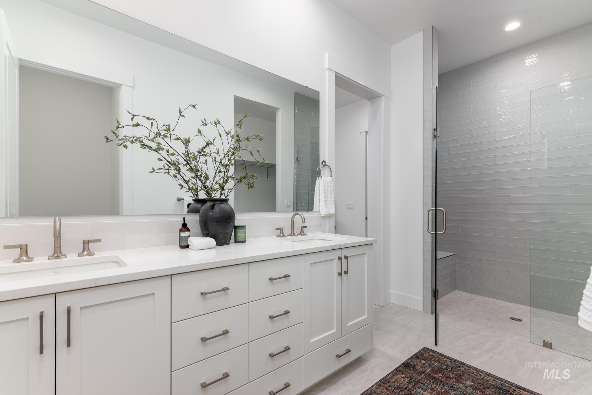 8629 West Stillmore Street Star, ID 83669 - Photo 19 of 27 Bathroom featuring a stall shower and double vanity