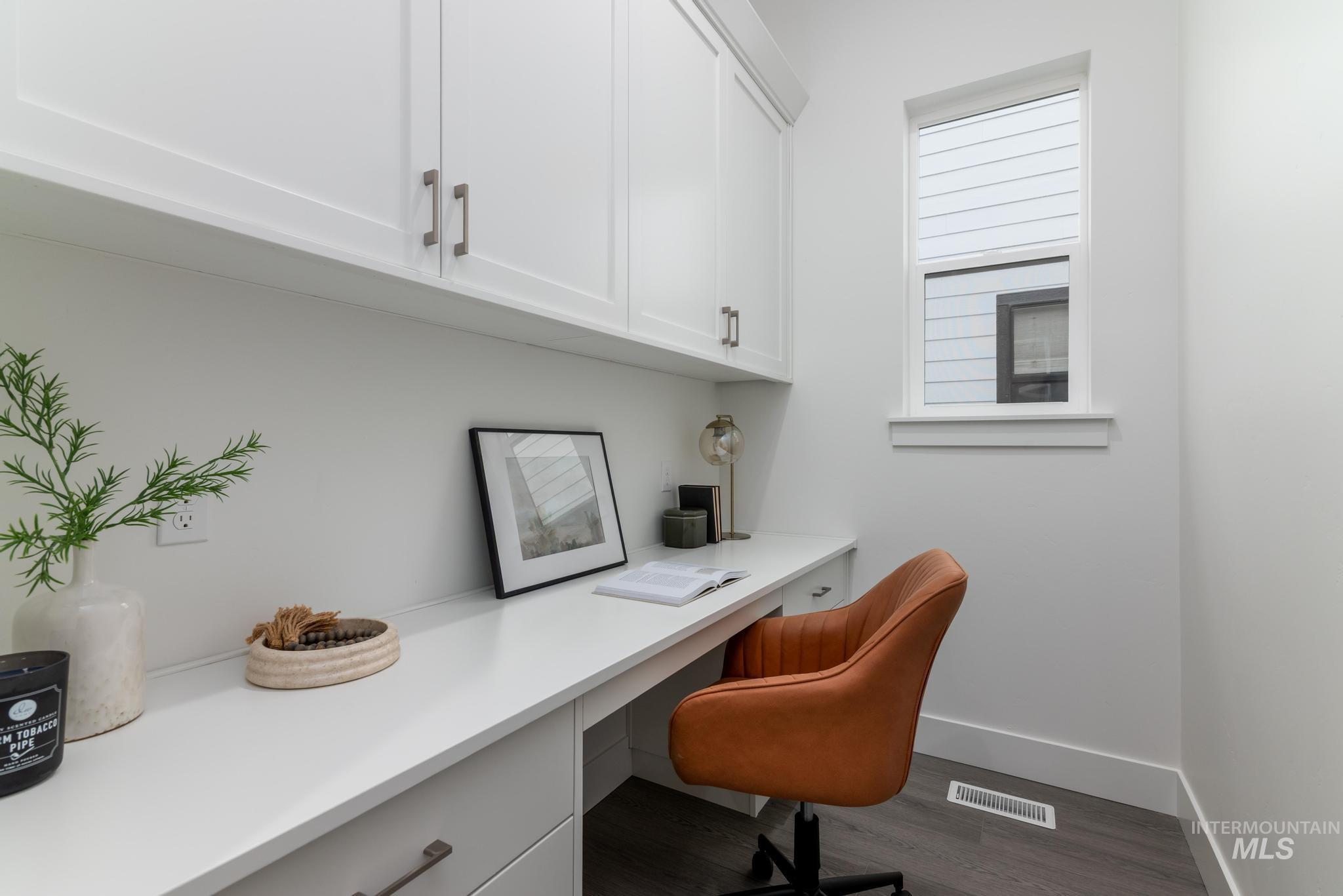 8629 West Stillmore Street Star, ID 83669 - Photo 22 of 27 Home office featuring built in desk and dark wood-style flooring