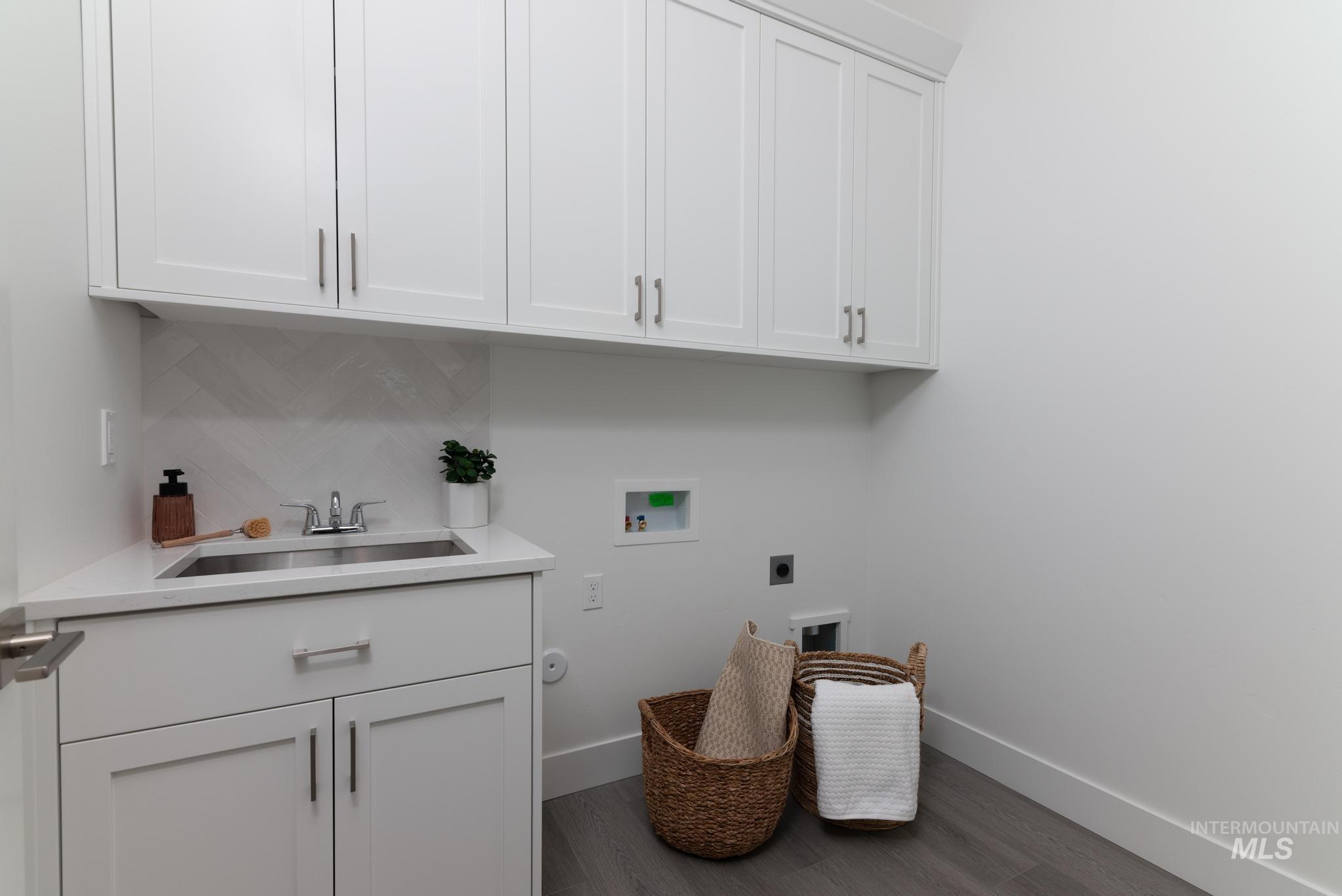 8629 West Stillmore Street Star, ID 83669 - Photo 23 of 27 Laundry area with hookup for a washing machine, electric dryer hookup, dark wood-type flooring, and cabinet space