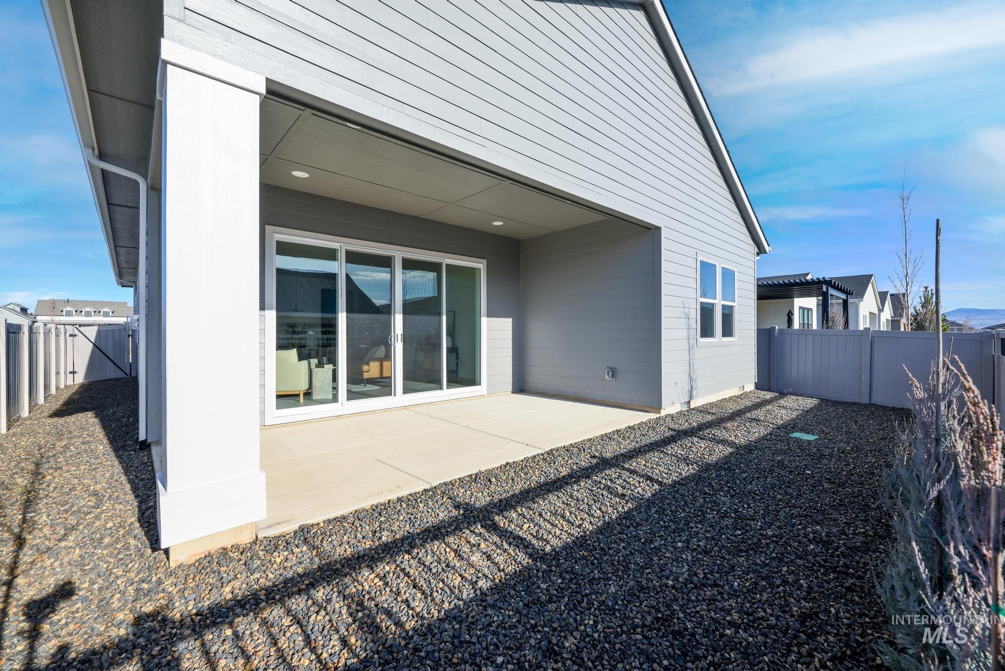 8629 West Stillmore Street Star, ID 83669 - Photo 24 of 27 Rear view of house with a fenced backyard and a patio