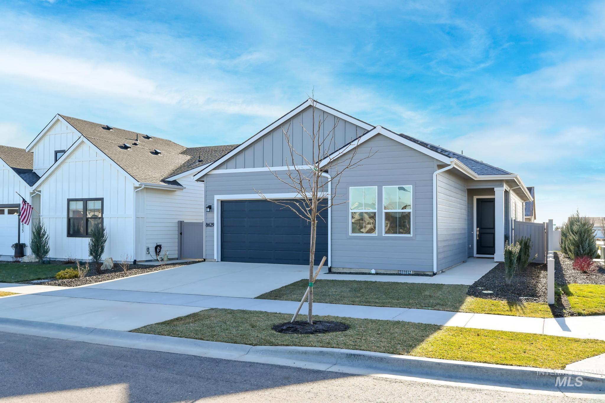 8629 West Stillmore Street Star, ID 83669 - Photo 3 of 27 Single story home featuring board and batten siding, driveway, a shingled roof, and an attached garage
