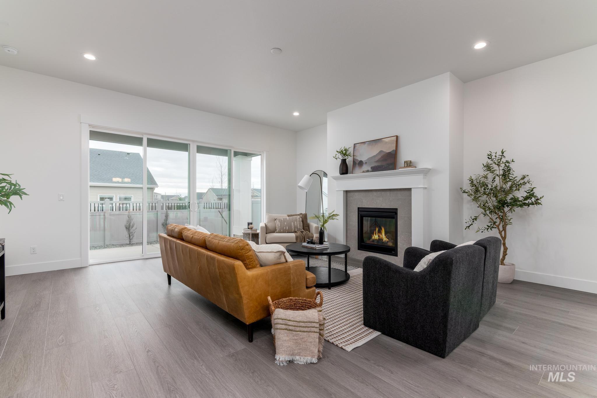 8629 West Stillmore Street Star, ID 83669 - Photo 6 of 27 Living area with a tile fireplace, light wood finished floors, and recessed lighting