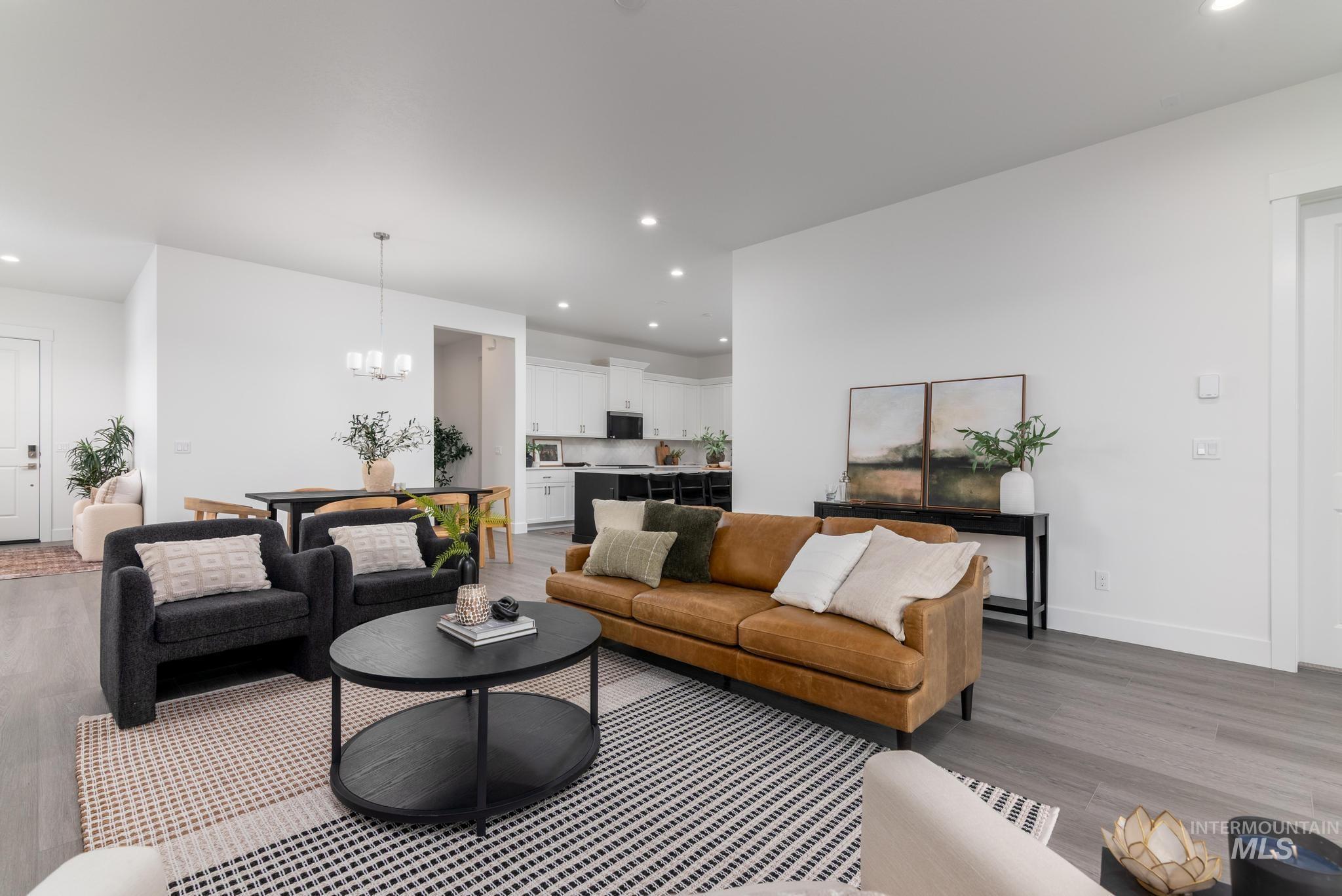 8629 West Stillmore Street Star, ID 83669 - Photo 8 of 27 Living area featuring recessed lighting, a chandelier, and wood finished floors
