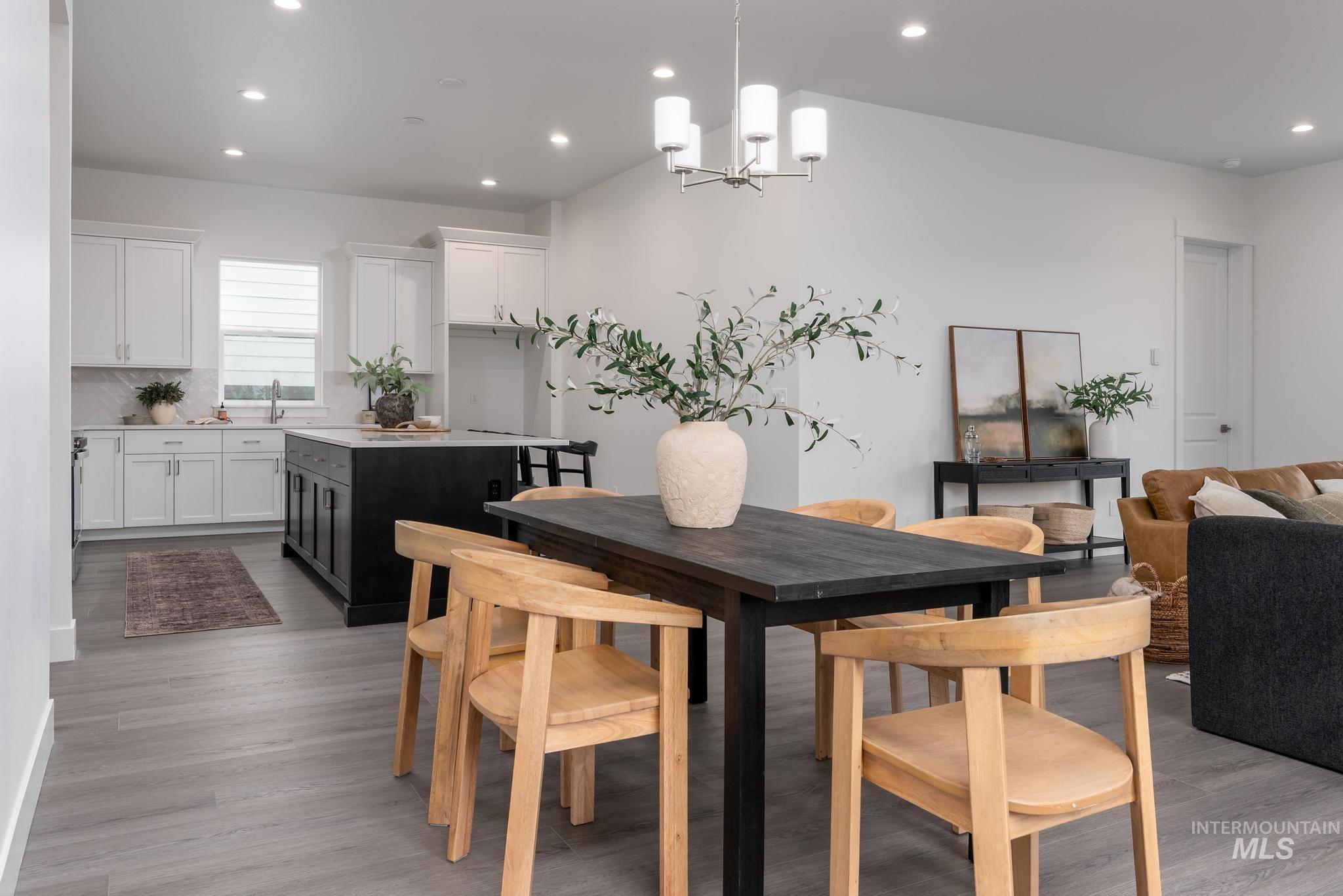 8629 West Stillmore Street Star, ID 83669 - Photo 9 of 27 Dining area with recessed lighting, a chandelier, and light wood-style floors