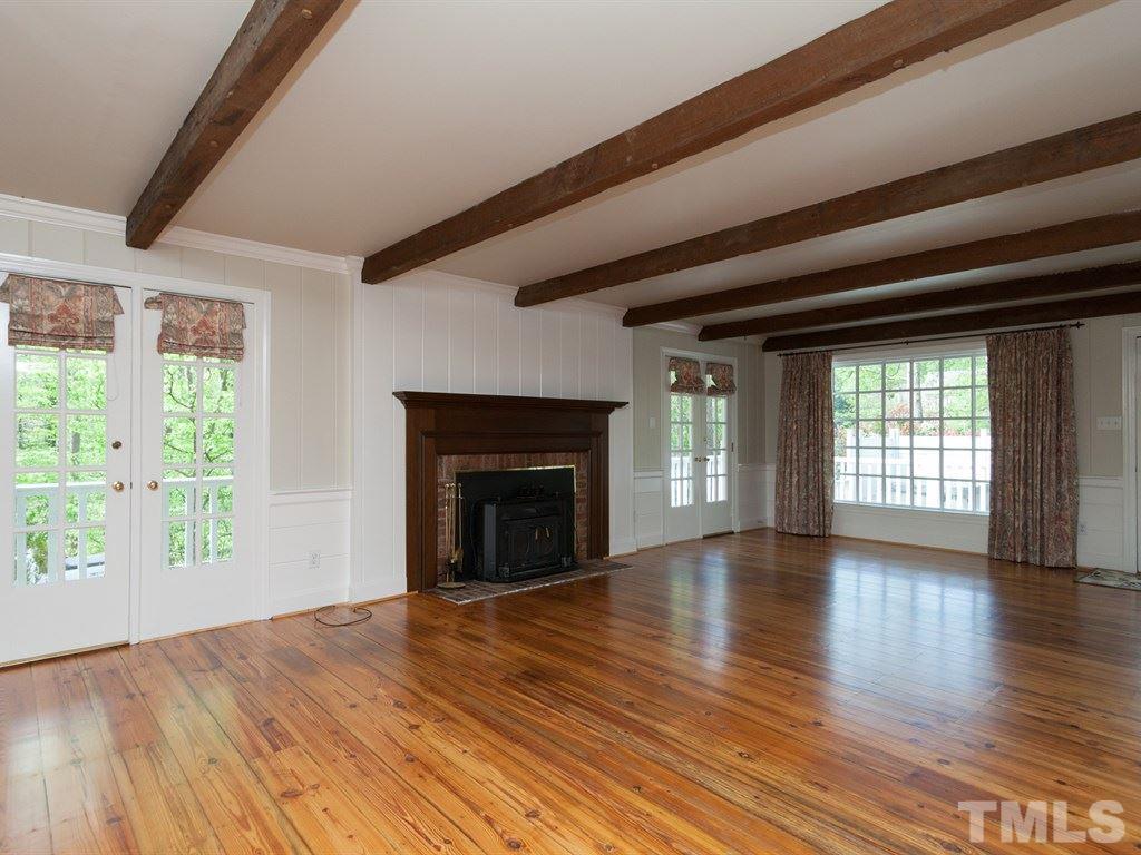 4909 Connell Drive Raleigh, NC 27612 - Photo 5 of 25 a view of an empty room with wooden floor and a window