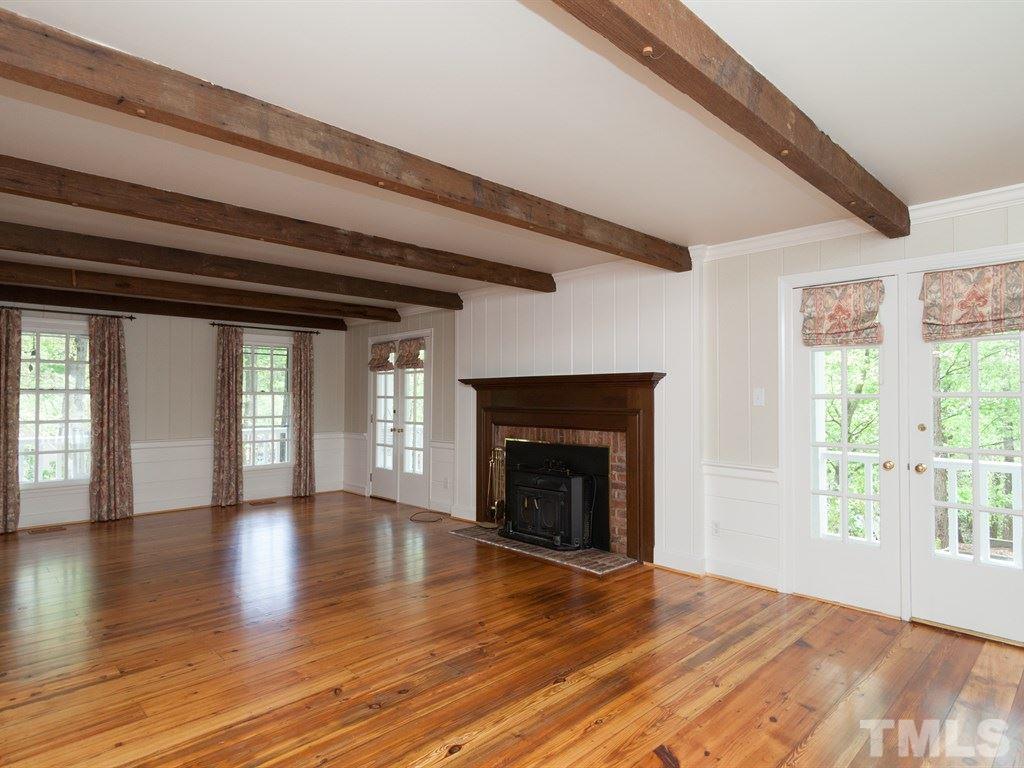 4909 Connell Drive Raleigh, NC 27612 - Photo 6 of 25 wooden floor fireplace and windows in an empty room