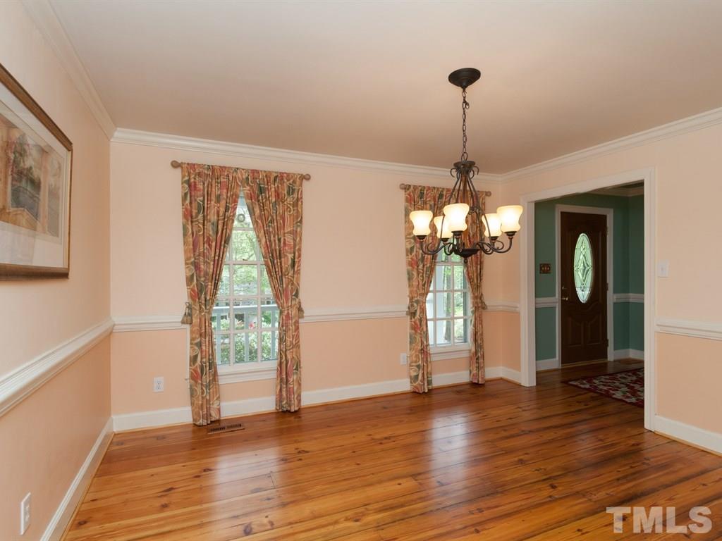 4909 Connell Drive Raleigh, NC 27612 - Photo 7 of 25 a view of a room with wooden floor staircase and a living room