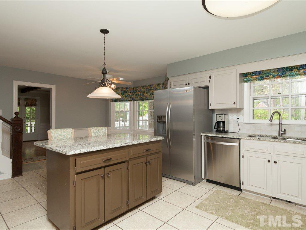 4909 Connell Drive Raleigh, NC 27612 - Photo 8 of 25 a kitchen with stainless steel appliances granite countertop a sink dishwasher a refrigerator and a stove