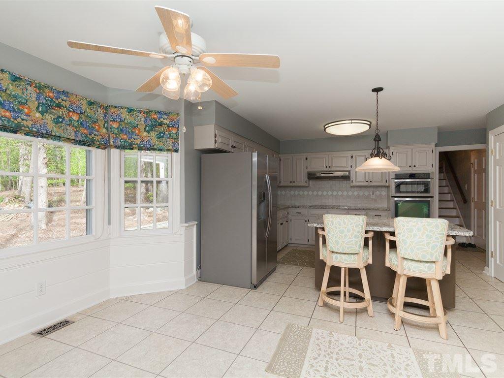 4909 Connell Drive Raleigh, NC 27612 - Photo 10 of 25 a dining room with furniture a chandelier and window