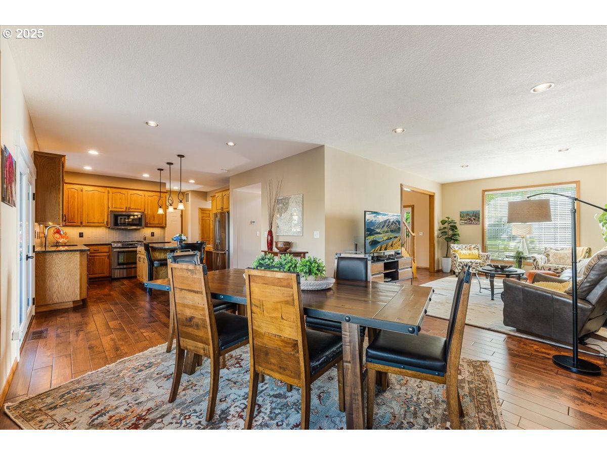 16706 Northwest Waterford Way Portland, OR 97229 - Photo 13 of 45 a dining room with furniture and a kitchen view