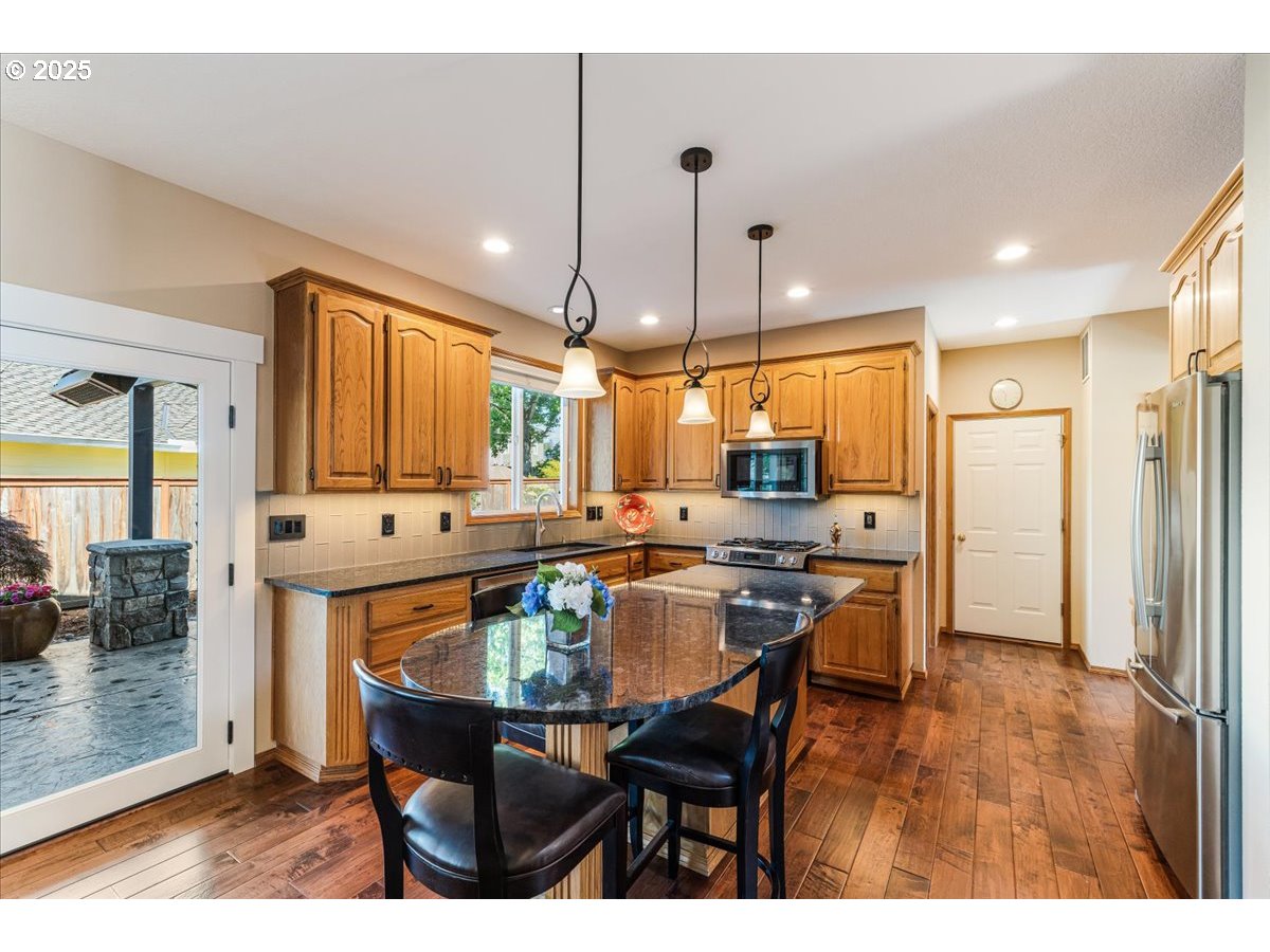 16706 Northwest Waterford Way Portland, OR 97229 - Photo 16 of 45 a kitchen with a table and chairs in it