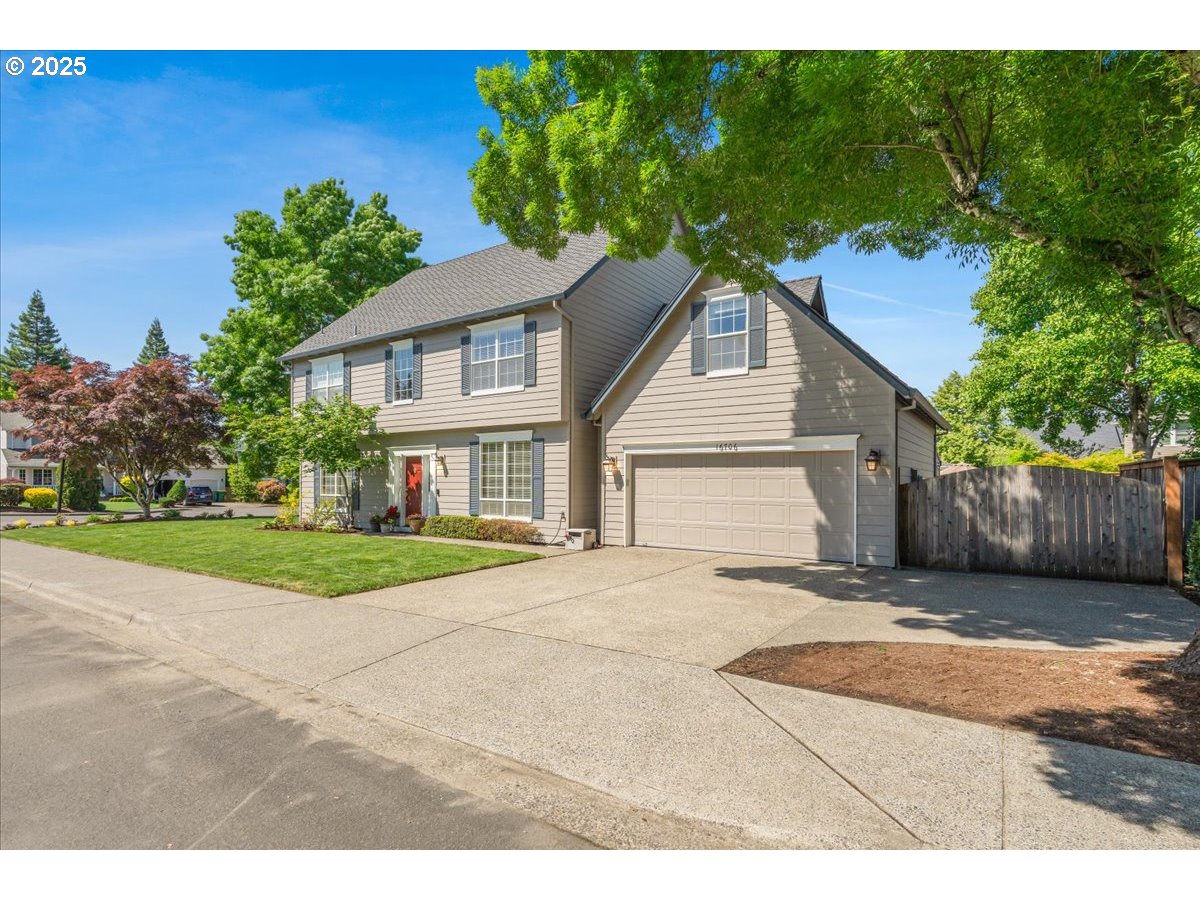 16706 Northwest Waterford Way Portland, OR 97229 - Photo 2 of 45 a view of a yard in front of a house with plants and large tree