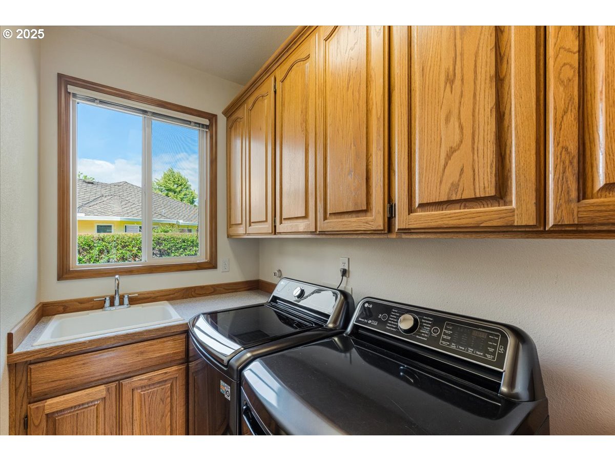 16706 Northwest Waterford Way Portland, OR 97229 - Photo 21 of 45 a kitchen with stainless steel appliances granite countertop a sink a stove and a microwave