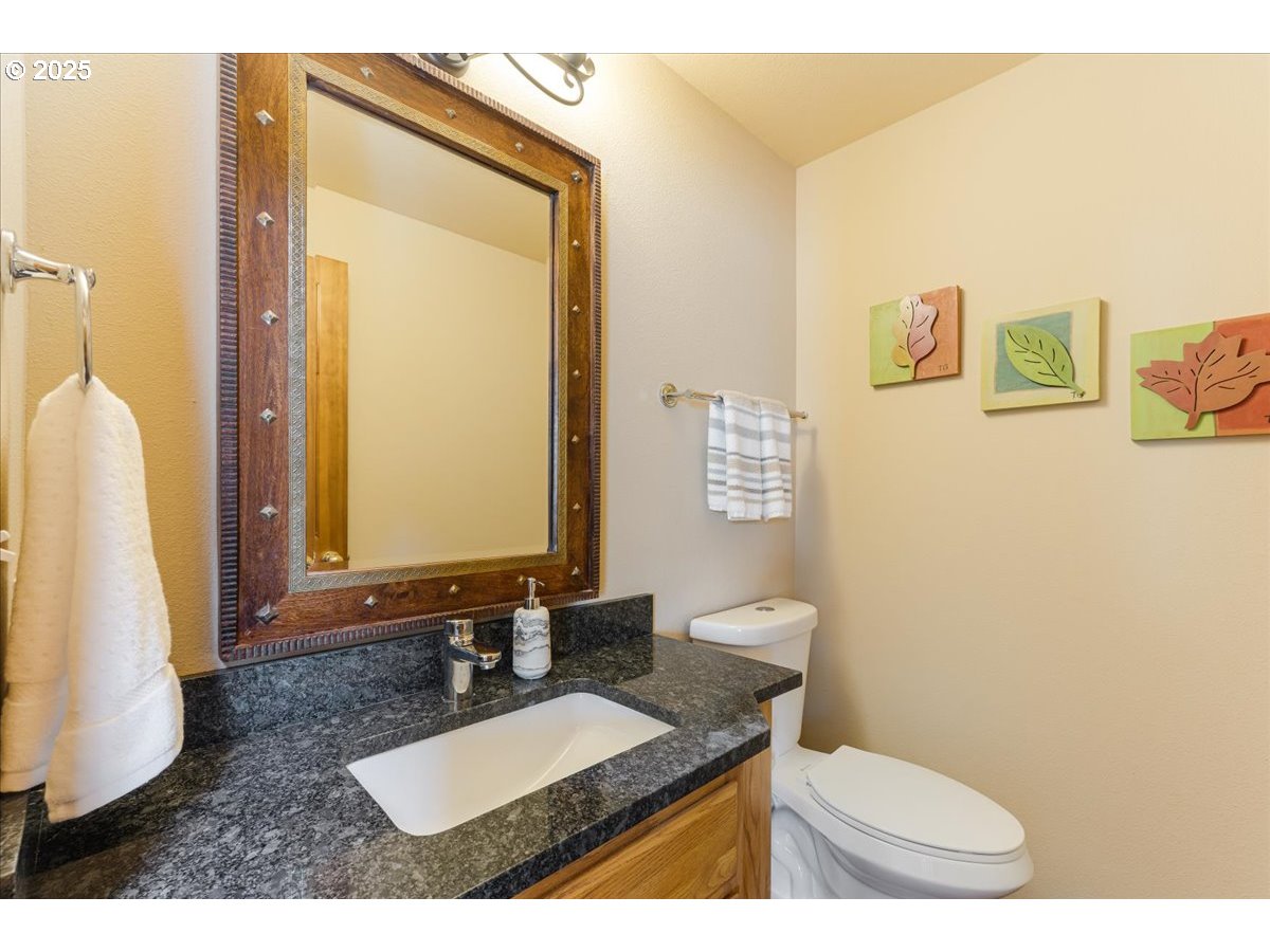 16706 Northwest Waterford Way Portland, OR 97229 - Photo 22 of 45 a bathroom with a granite countertop sink mirror vanity and toilet