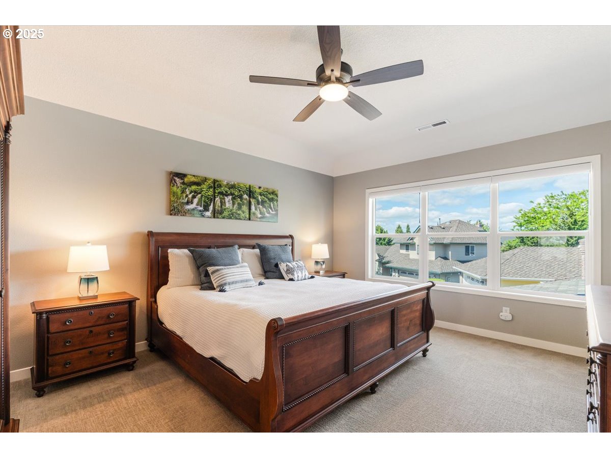 16706 Northwest Waterford Way Portland, OR 97229 - Photo 24 of 45 a bedroom with a bed and a large window