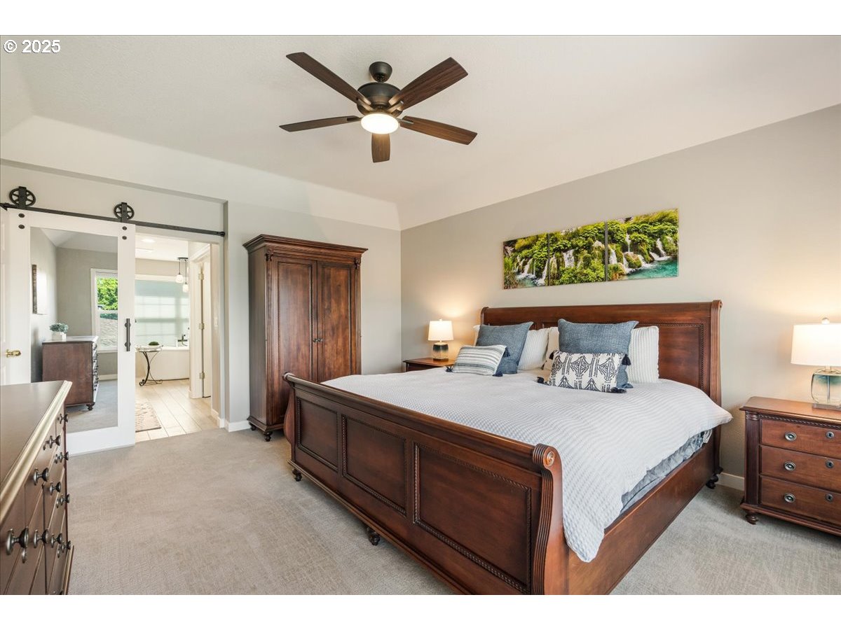 16706 Northwest Waterford Way Portland, OR 97229 - Photo 26 of 45 a bedroom with a bed a table and painting