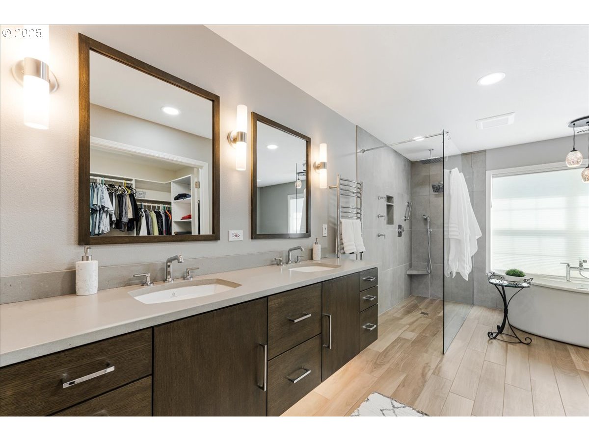 16706 Northwest Waterford Way Portland, OR 97229 - Photo 28 of 45 a bathroom with a sink double vanity granite tub shower and a mirror