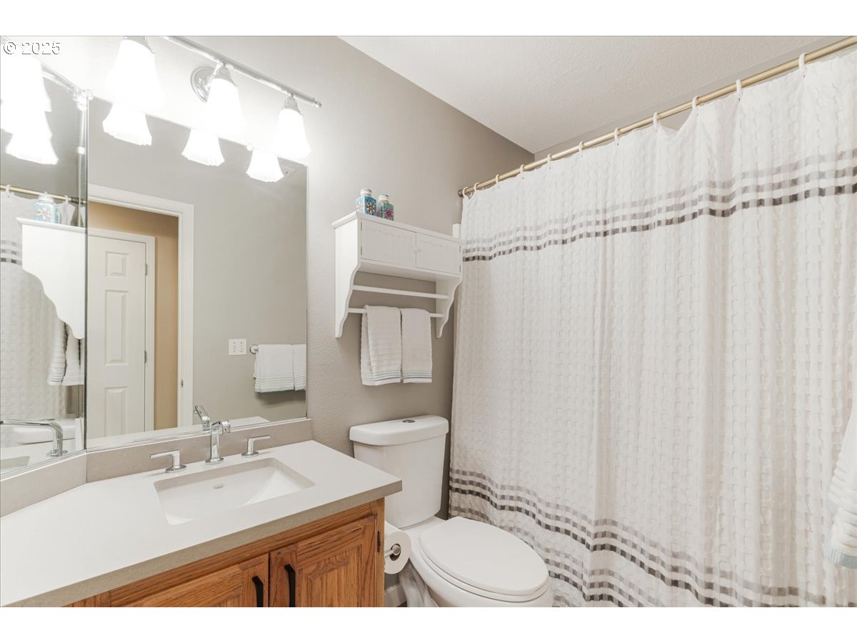 16706 Northwest Waterford Way Portland, OR 97229 - Photo 37 of 45 a bathroom with a sink vanity mirror and a toilet