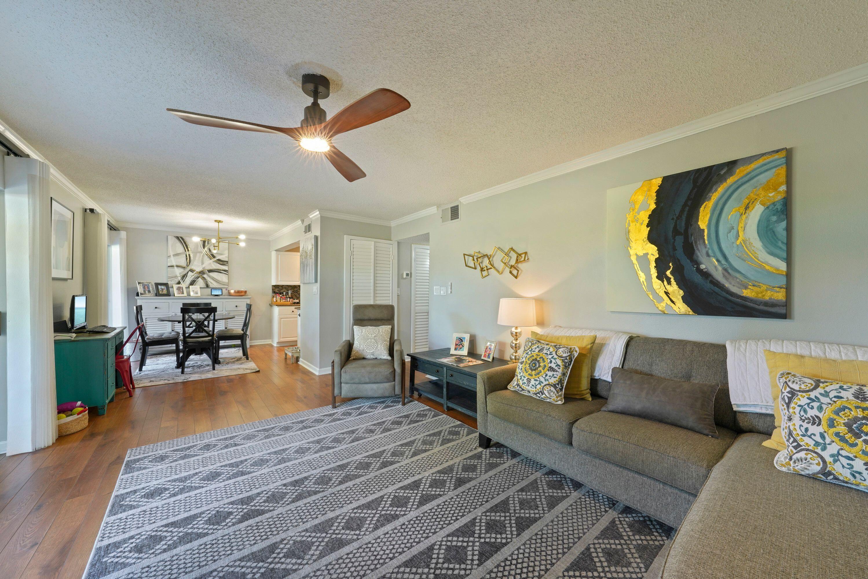 283 Sunset Bay, Unit 28B Miramar Beach, FL 32550 - Photo 12 of 23 a living room with furniture and wooden floor