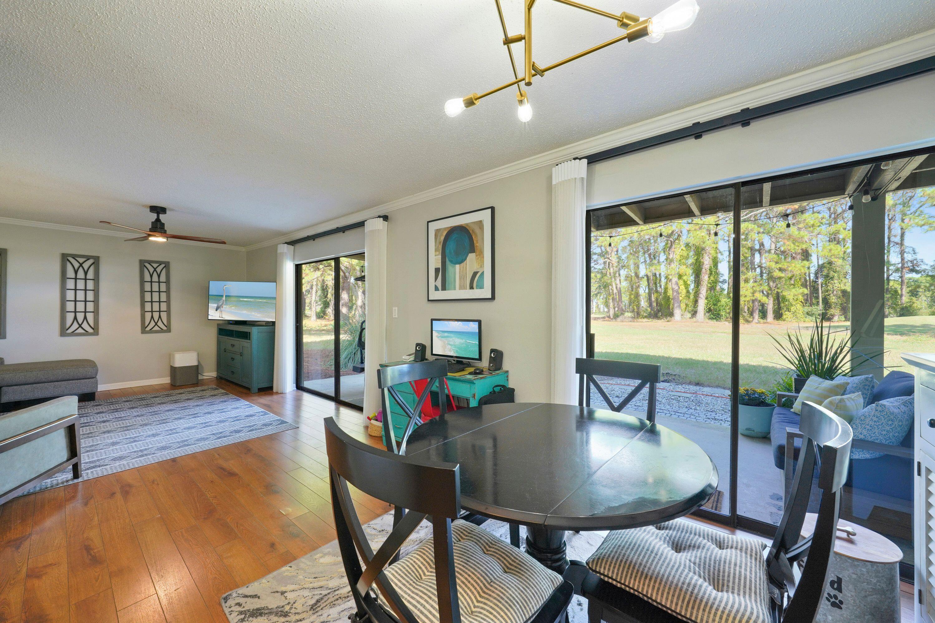 283 Sunset Bay, Unit 28B Miramar Beach, FL 32550 - Photo 13 of 23 a view of a dining room with furniture window and wooden floor