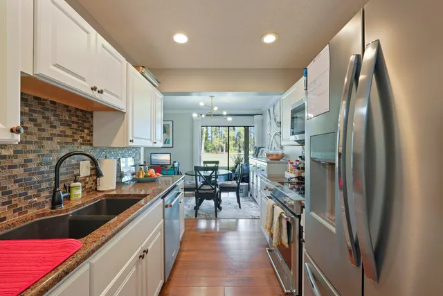 a kitchen with stainless steel appliances a refrigerator sink and cabinets