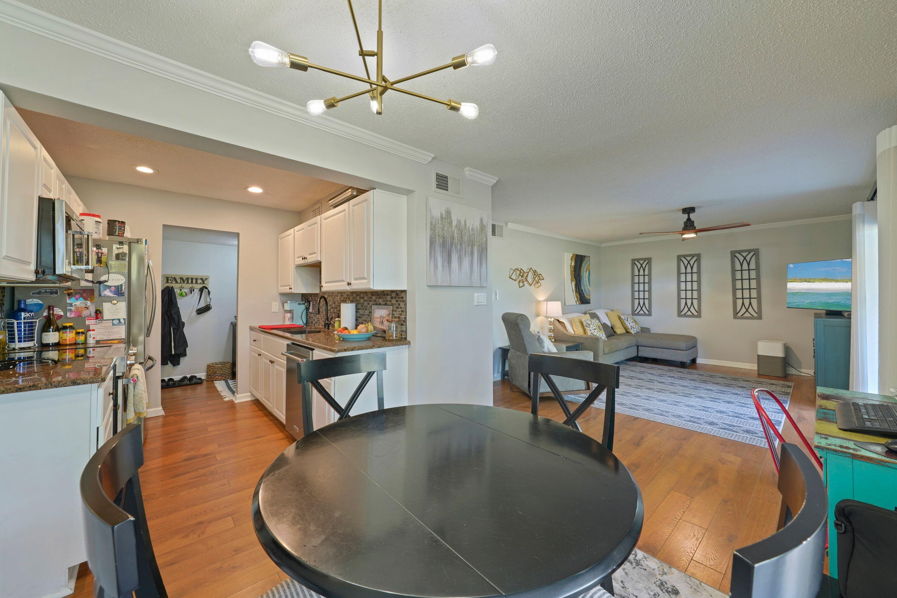 283 Sunset Bay, Unit 28B Miramar Beach, FL 32550 - Photo 15 of 23 a living room with furniture a dining table and kitchen view
