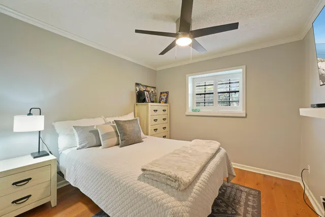 a bedroom with a bed and a chandelier