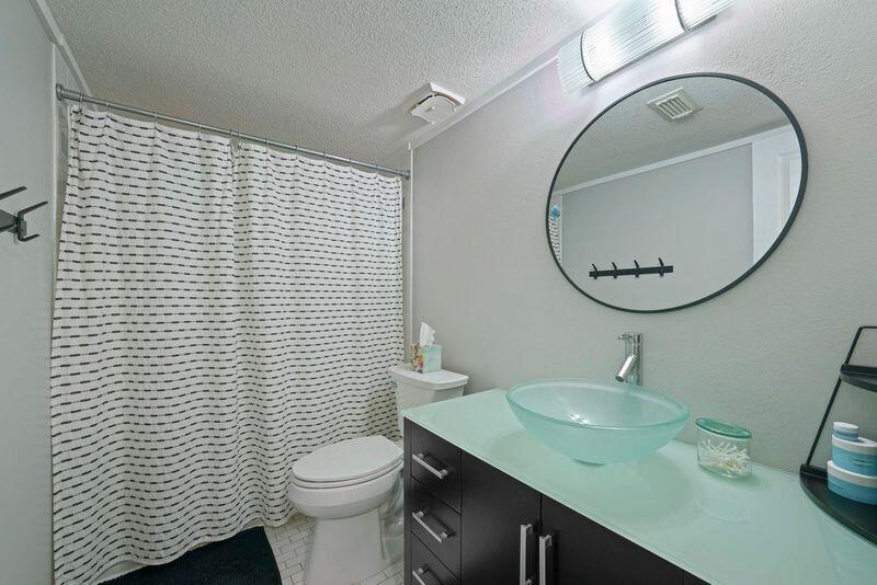 283 Sunset Bay, Unit 28B Miramar Beach, FL 32550 - Photo 19 of 23 a bathroom with a sink a toilet and mirror