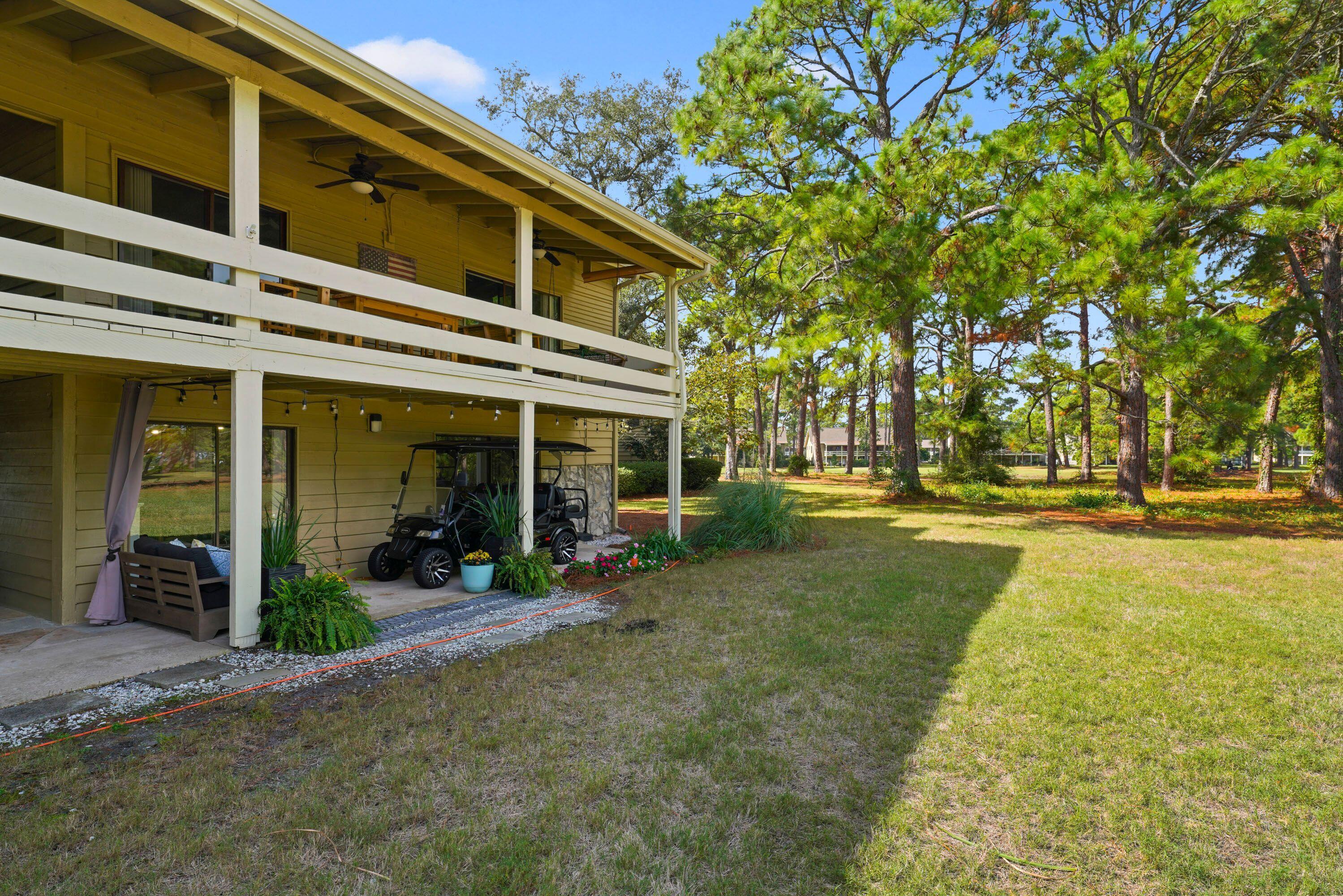 283 Sunset Bay, Unit 28B Miramar Beach, FL 32550 - Photo 2 of 23 a front view of a building with a garden