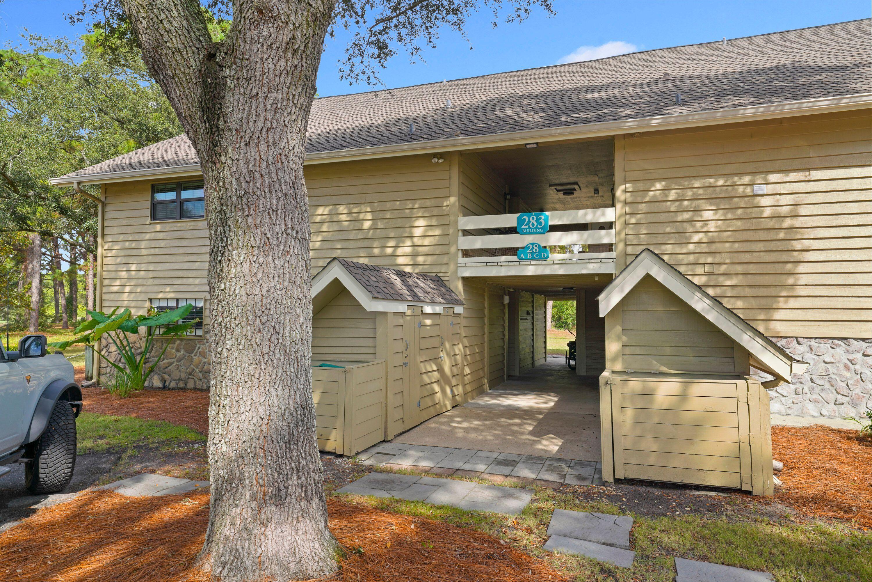 283 Sunset Bay, Unit 28B Miramar Beach, FL 32550 - Photo 3 of 23 a front view of a house with a yard