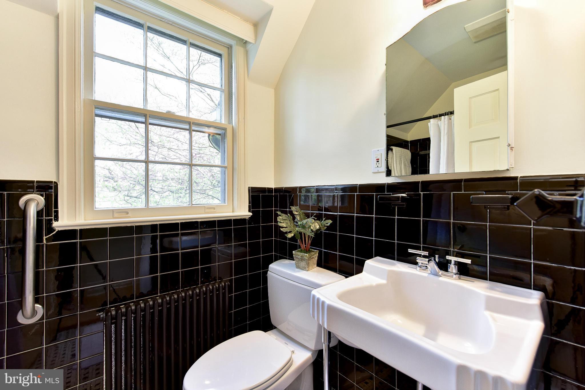 4108 Dresden Street Kensington, MD 20895 - Photo 17 of 24 a bathroom with a sink a toilet and window