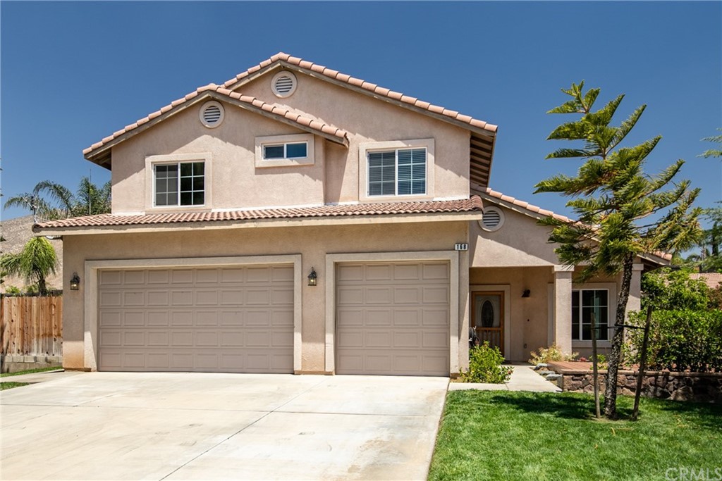 168 Carlin Lane Riverside, CA 92507 - Photo 1 of 1 a front view of a house with a yard and garage
