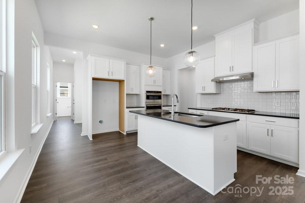 3117 Beacon Hts Road Indian Land, SC 29707 - Photo 4 of 40 a large kitchen with stainless steel appliances and wooden floor